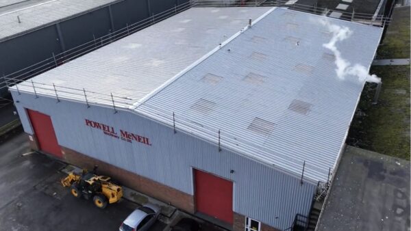 Industrial unit with a new metal roof installed over the old roof