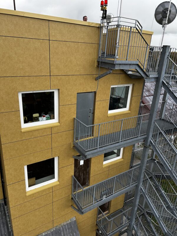 Rainscreen panels around windows and a steel stair landing
