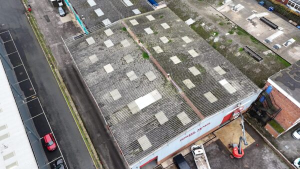 Aerial view of an aging cement-sheet roof before a metal roof-over
