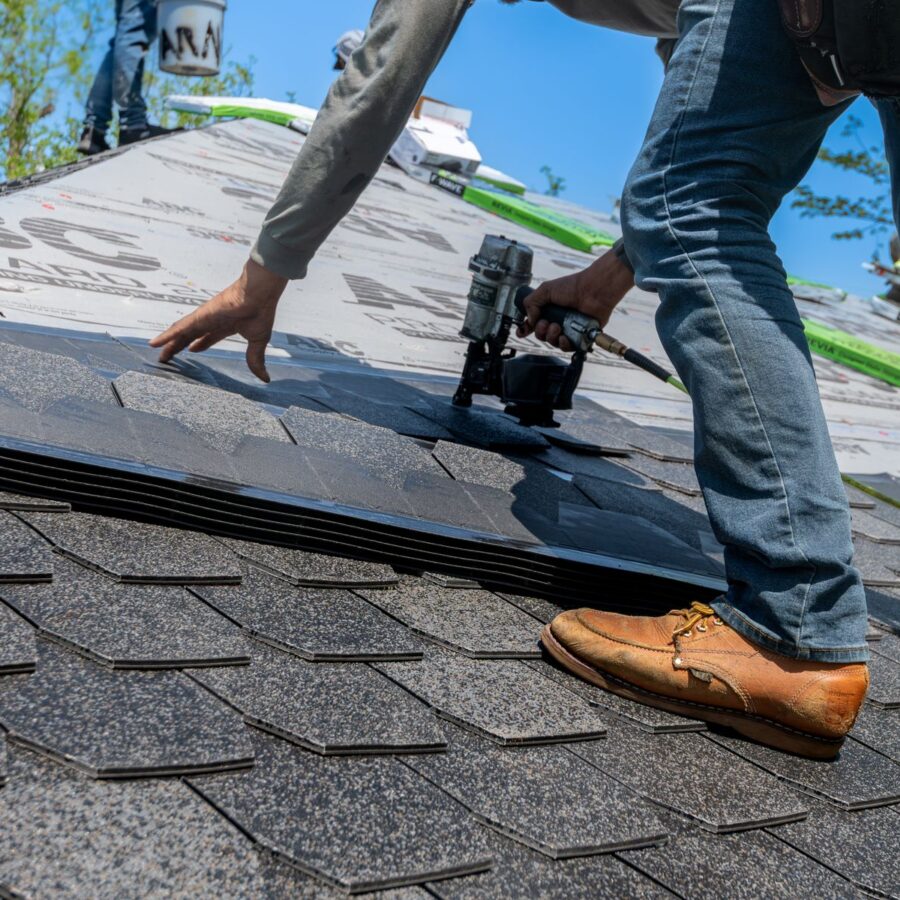 Roofing professional installing shingles on a Texas home