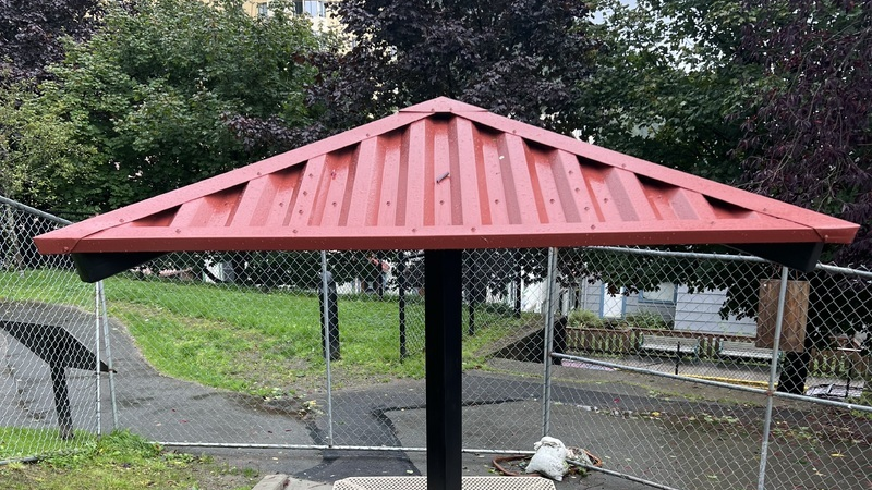 Red McElroy Mega-Rib roof panels on an RCP Shelters park structure