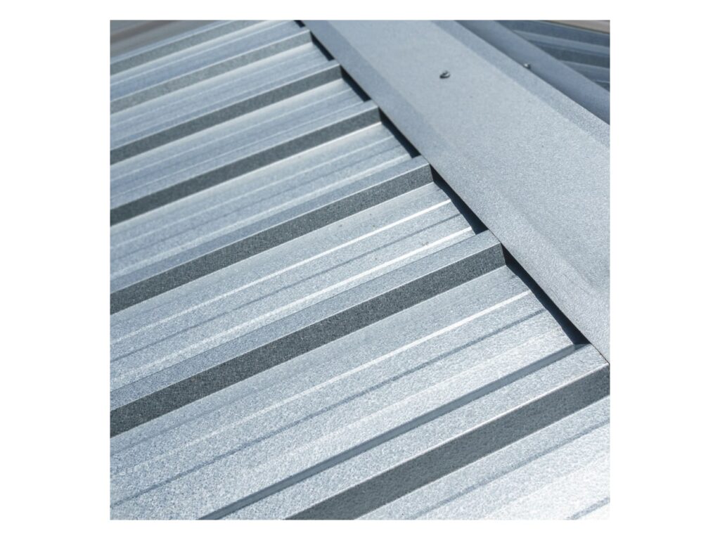 Galvalume R-Panel ribbed metal roof panels installed with a ridge trim piece