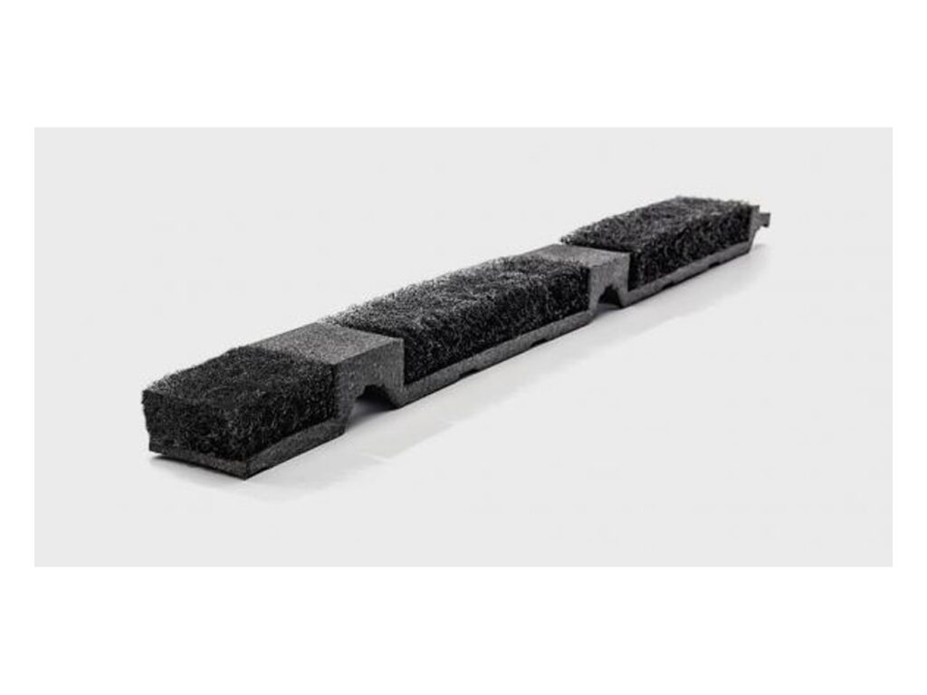 Black polyester LP2 ridge vent strip with three fiber vent inserts and notched profile cuts