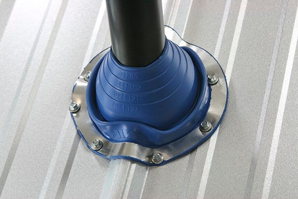 Blue Universal Master Flash sealing a pipe on a ribbed metal roof
