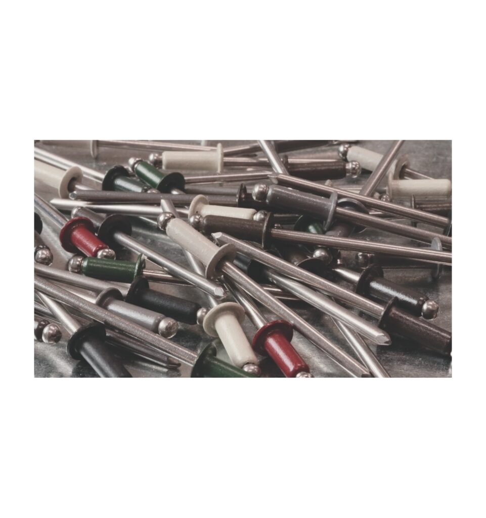 Pile of painted stainless steel domed head blind rivets in assorted colors on sheet metal
