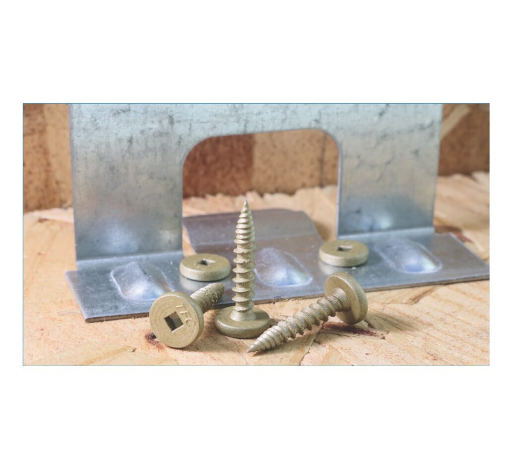Burr Buster pancake head screws lying beside a standing seam clip on OSB