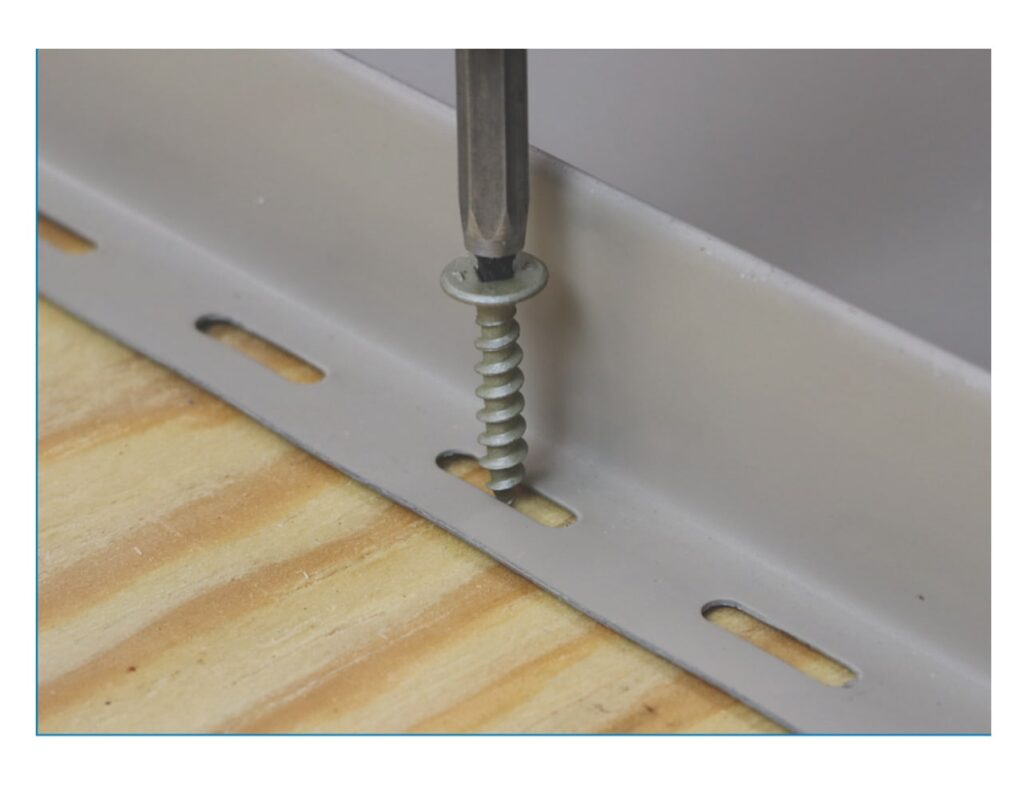 ULP pancake head screw fastening a slotted standing seam clip to wood